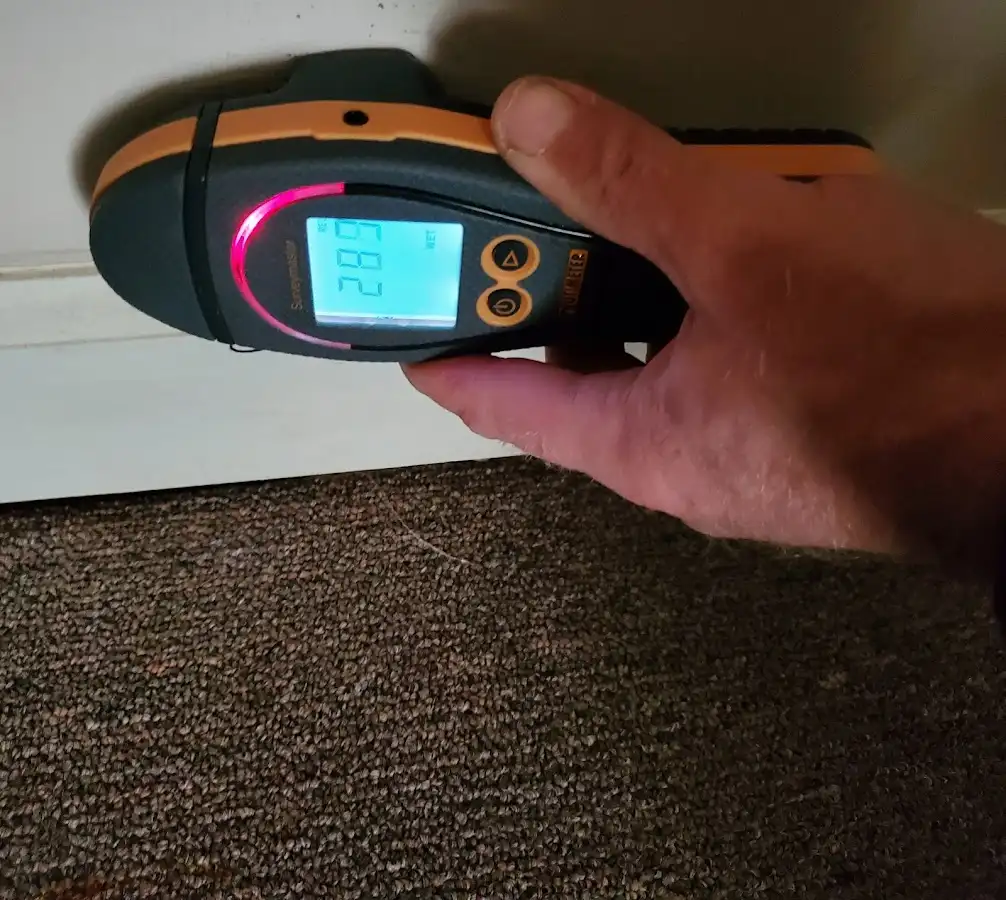 Moisture detection at baseboard during Storm Damage Restoration in Newport